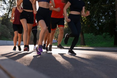 Photo of Group of people running outdoors on summer day, closeup