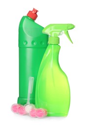Photo of Toilet rim block cleaner and bottles on white background