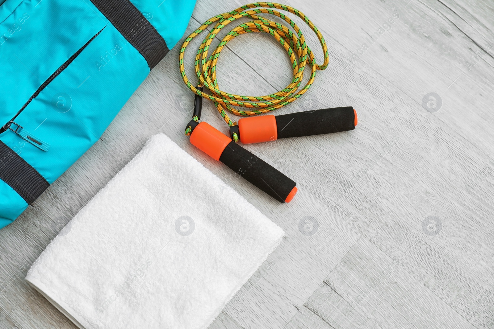 Photo of Flat lay composition with sports bag on wooden floor