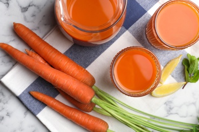 Flat lay composition with carrot drink and ingredients on marble table