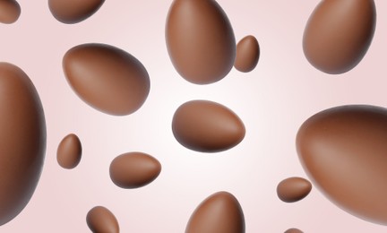 Image of Many chocolate eggs falling on pale light pink background