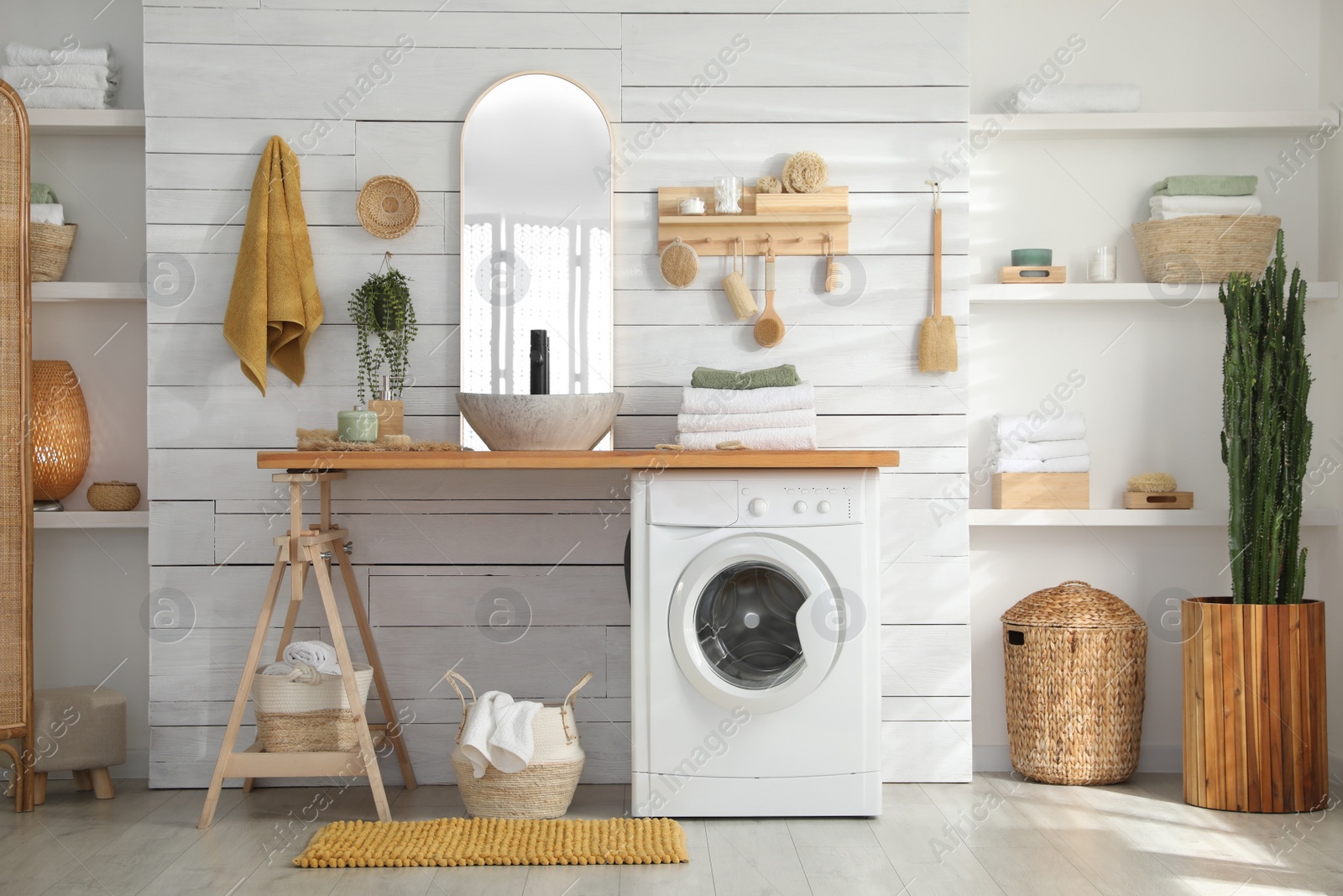 Photo of Stylish bathroom interior with modern washing machine