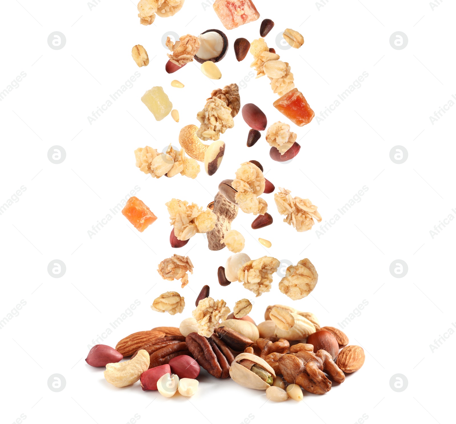 Image of Delicious granola, nuts and dried fruits falling into pile on white background. Healthy snack 