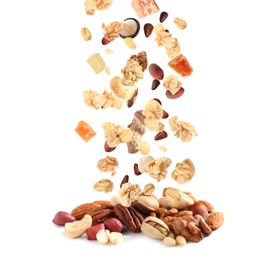 Image of Delicious granola, nuts and dried fruits falling into pile on white background. Healthy snack 