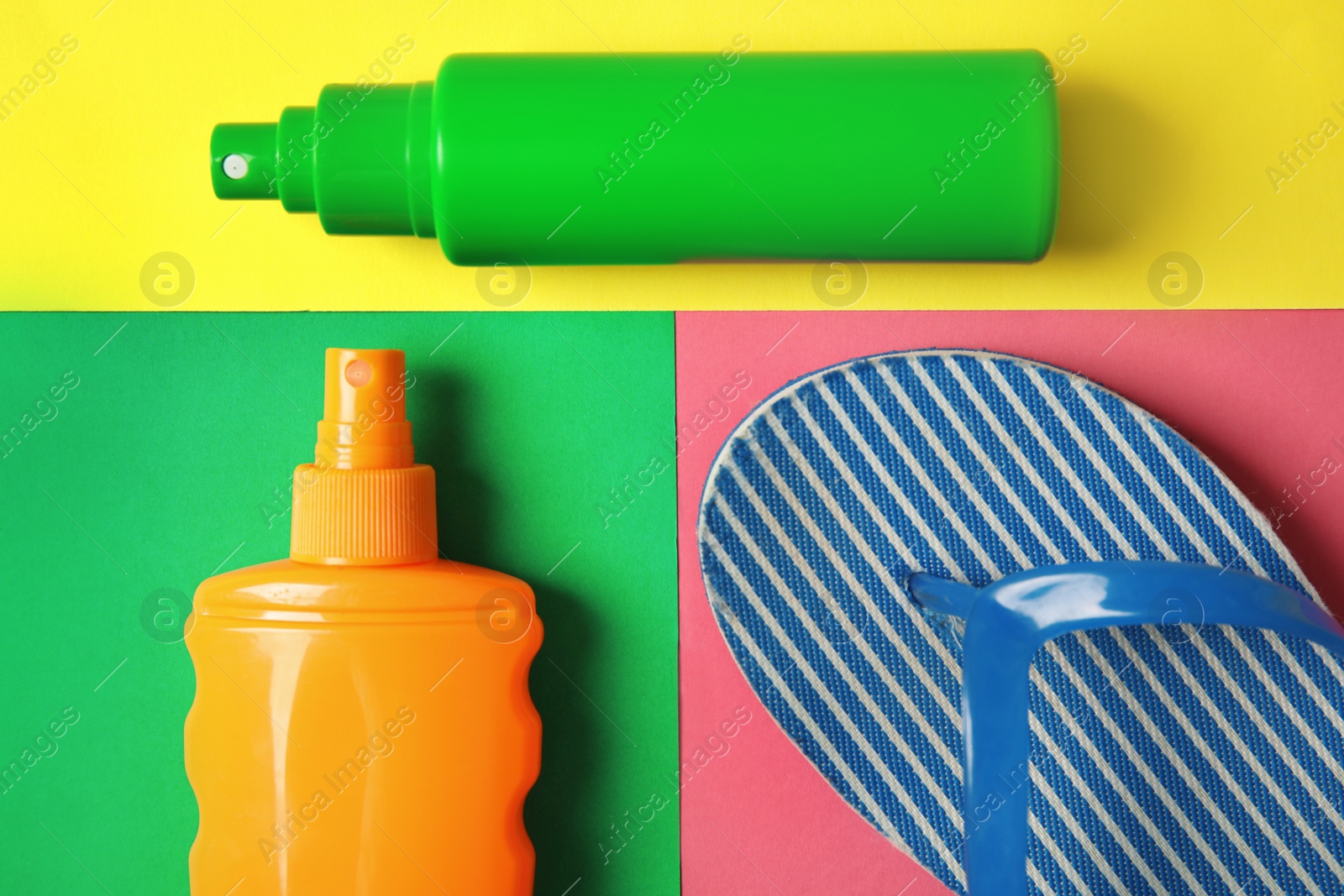 Photo of Flat lay composition with sun protection products on color background