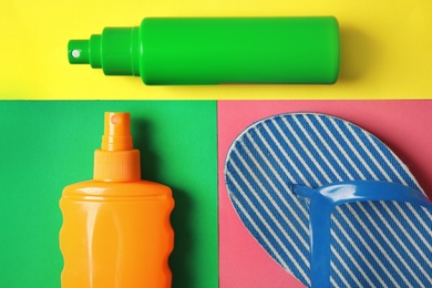 Photo of Flat lay composition with sun protection products on color background