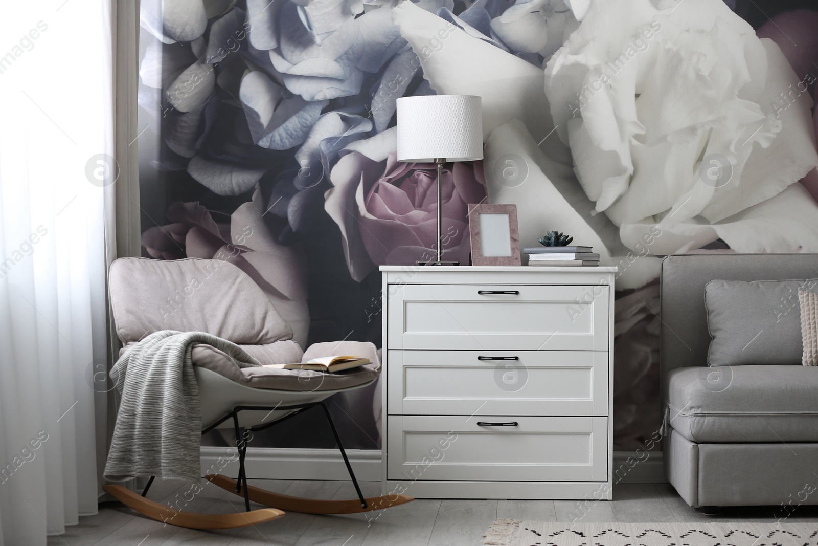 Photo of White chest of drawers in stylish living room. Interior design