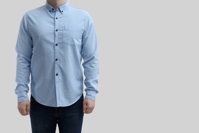 Photo of Man wearing clean shirt on white background, closeup. Space for text