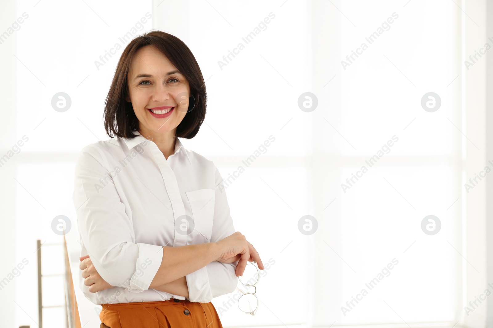 Photo of Happy mature businesswoman in office. Space for text