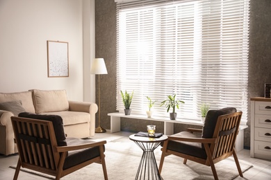 Photo of Living room interior with comfortable sofa and armchairs