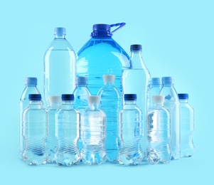 Photo of Set of different plastic bottles with pure water on color background