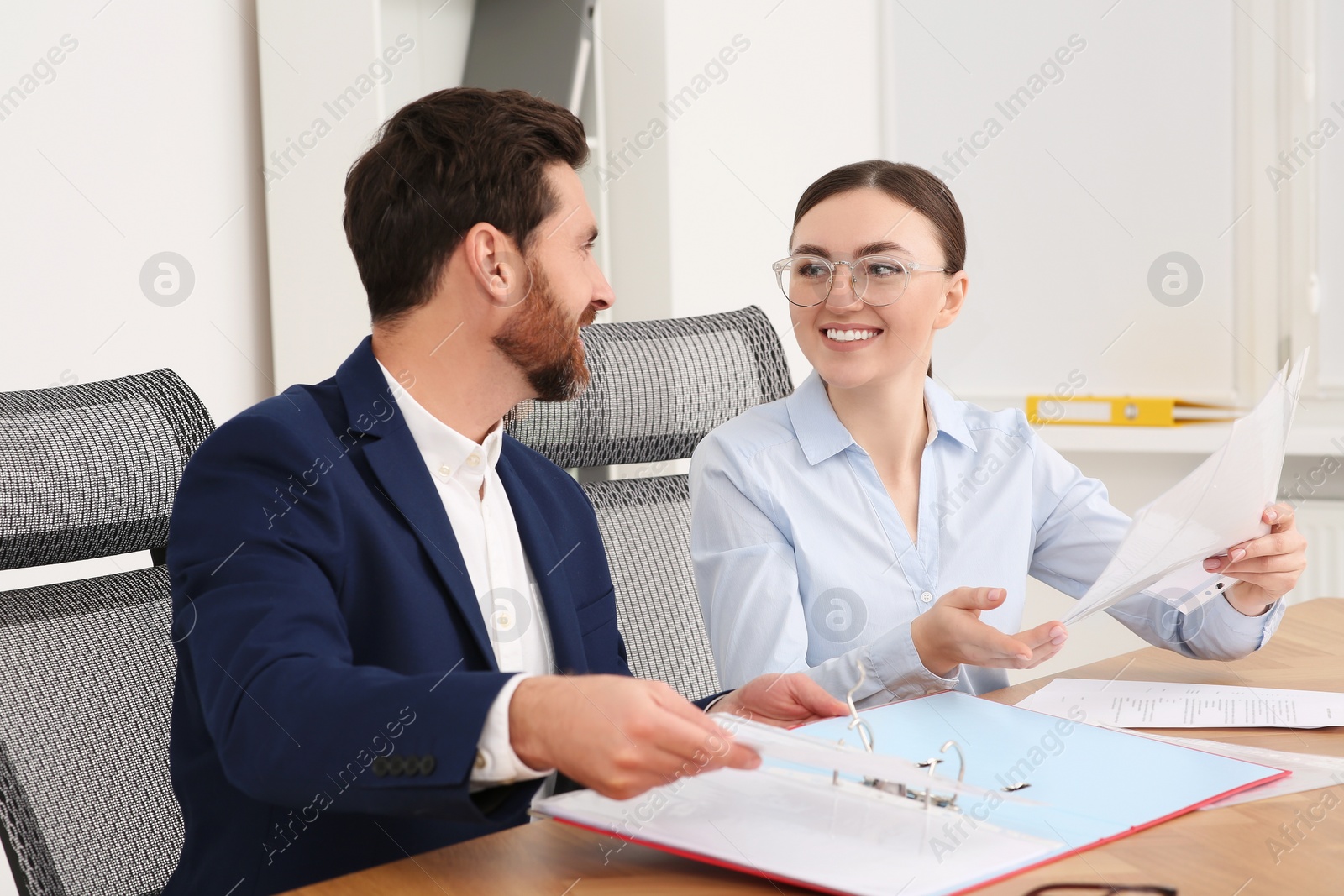 Photo of Businesspeople working together with documents in office