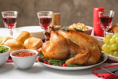 Photo of Traditional festive dinner with delicious roasted turkey served on table