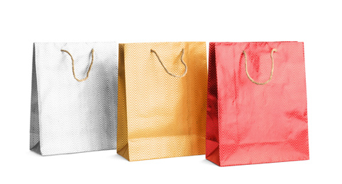 Photo of Color paper shopping bags isolated on white. Space for design