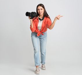Photo of Professional photographer working on white background in studio