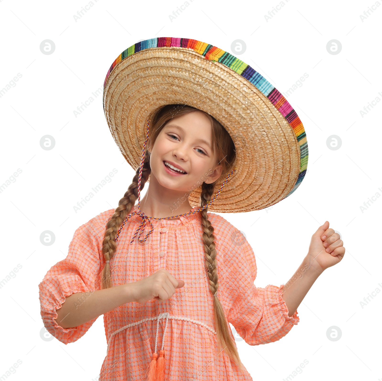 Photo of Cute girl in Mexican sombrero hat dancing on white background