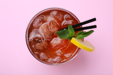 Photo of Delicious iced tea with lemon and mint on pink background, top view