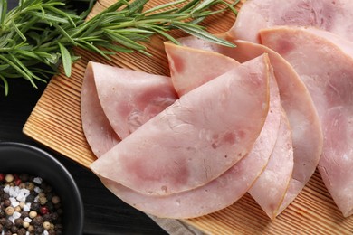 Photo of Slices of delicious ham with rosemary and spices on dark wooden table, flat lay