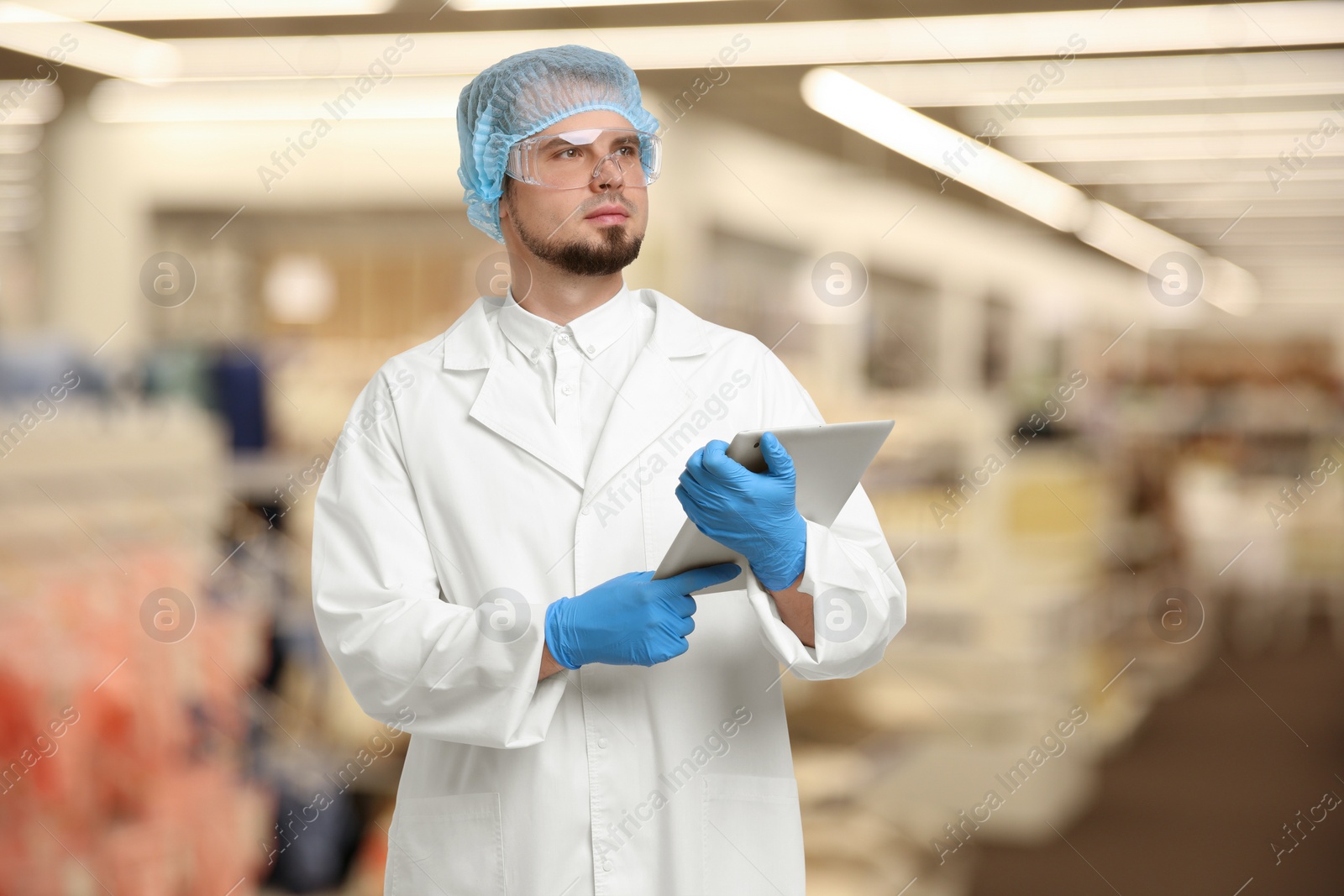 Image of Food quality control specialist examining products in supermarket