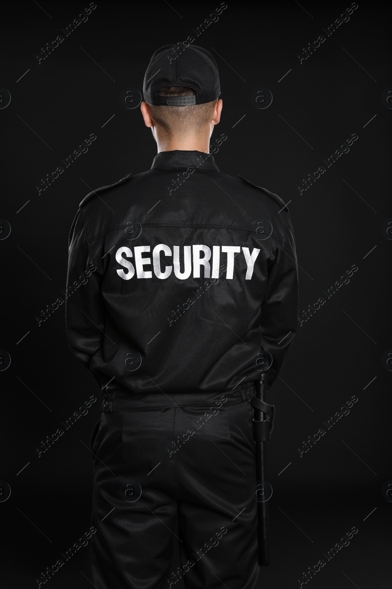 Photo of Male security guard in uniform on dark background