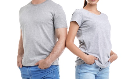 Young couple in t-shirts on white background. Mockup for design