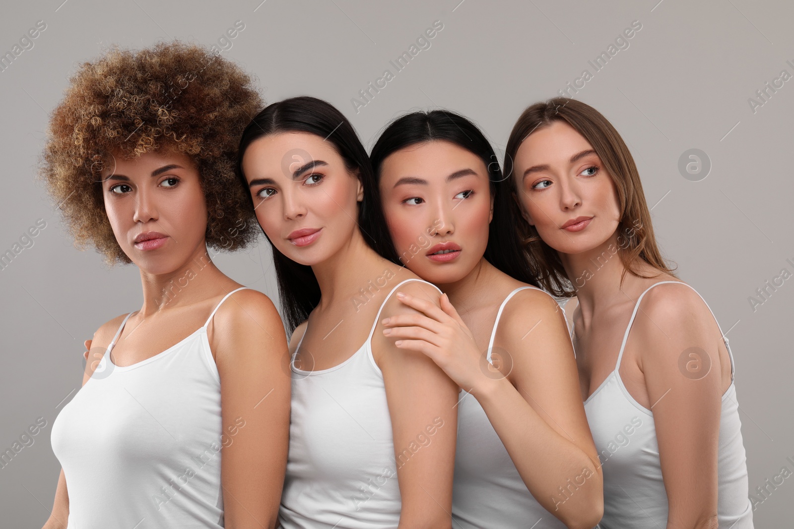 Photo of Beautiful young women with healthy skin on gray background