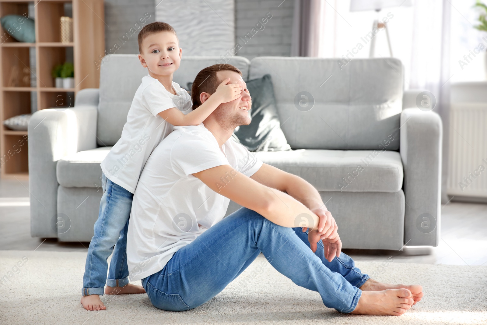 Photo of Happy dad and his son playing at home. Father's day celebration