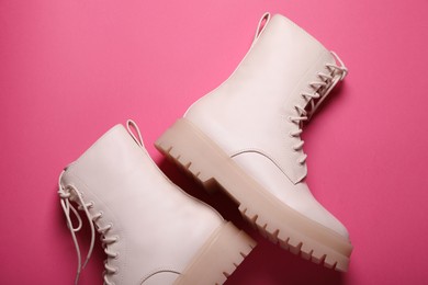 Pair of stylish leather shoes on pink background, flat lay