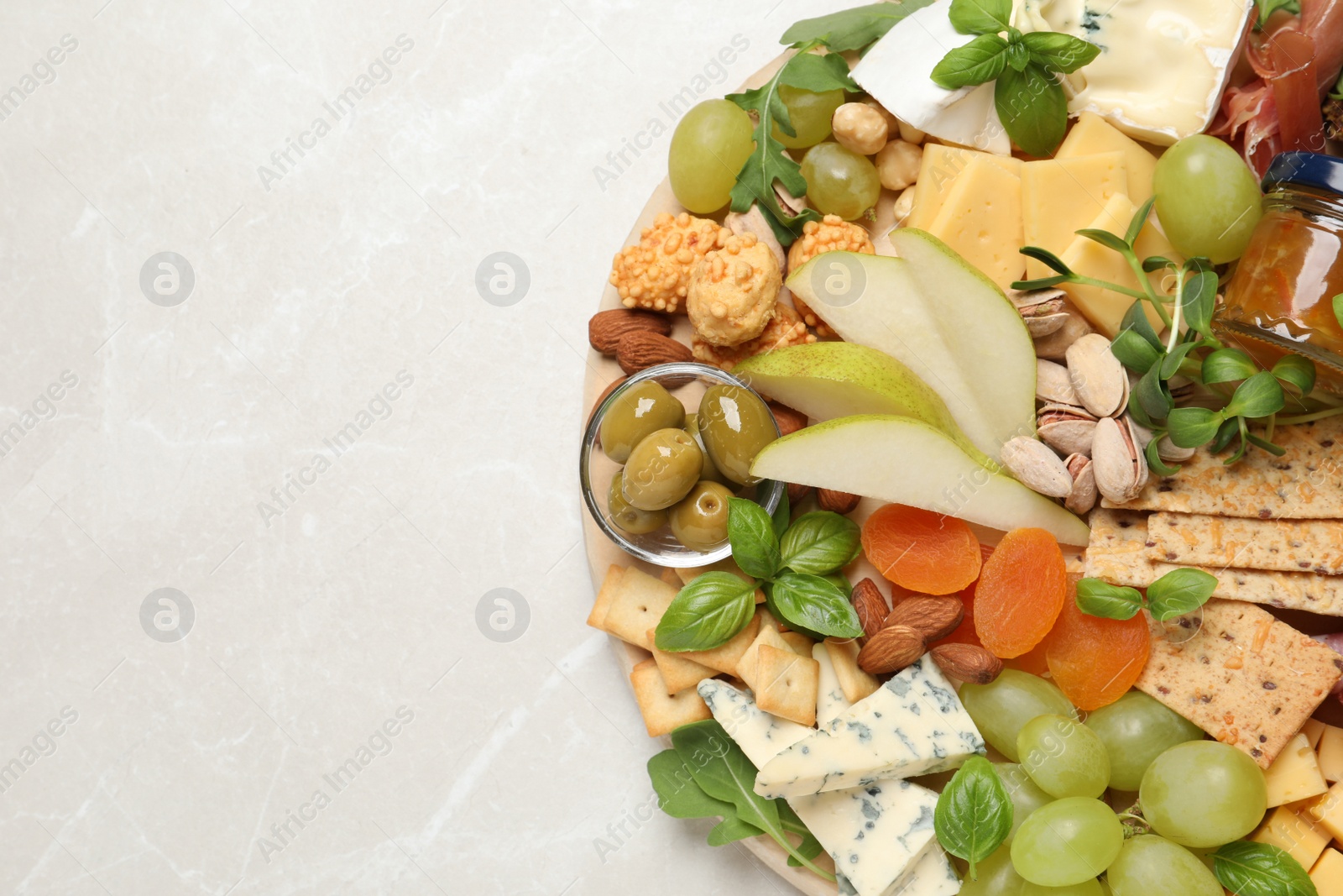 Photo of Different tasty appetizers on light table, top view. Space for text