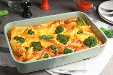 Tasty broccoli casserole in baking dish on table