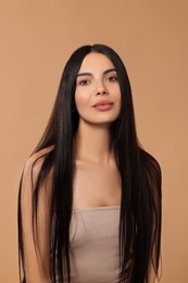 Photo of Beautiful woman with long hair on beige background