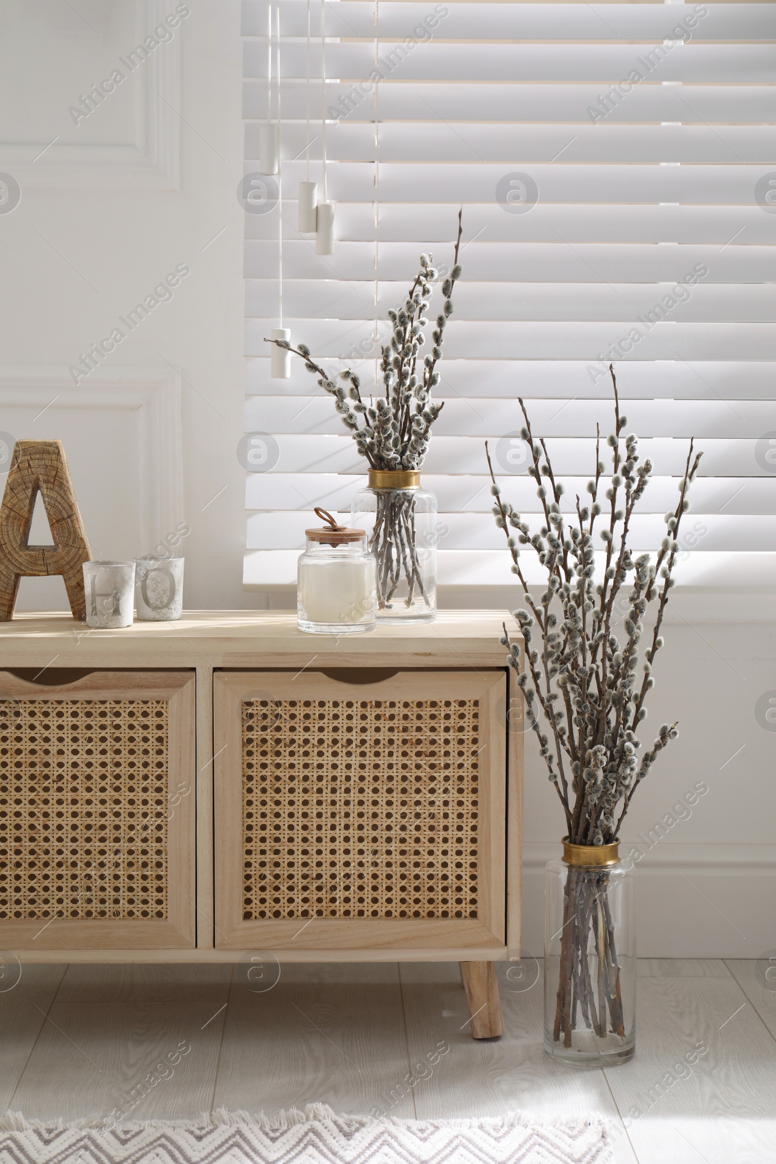 Photo of Light room interior with pussy willow tree branches