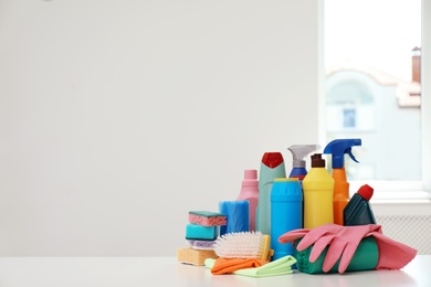 Photo of Set of cleaning supplies on table indoors