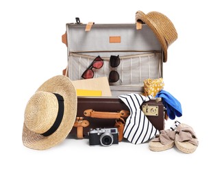 Photo of Clothes, camera and suitcase on white background. Prepare for travel