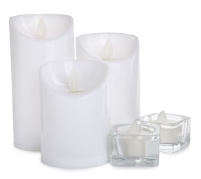 Photo of Different decorative flameless LED candles on white background