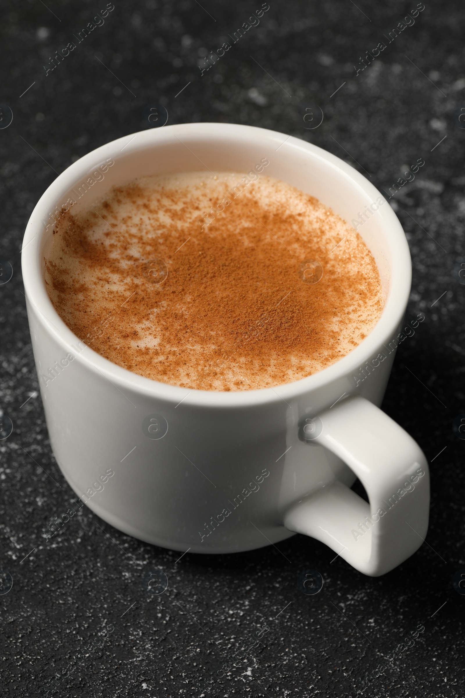 Photo of Cup of delicious eggnog on grey table