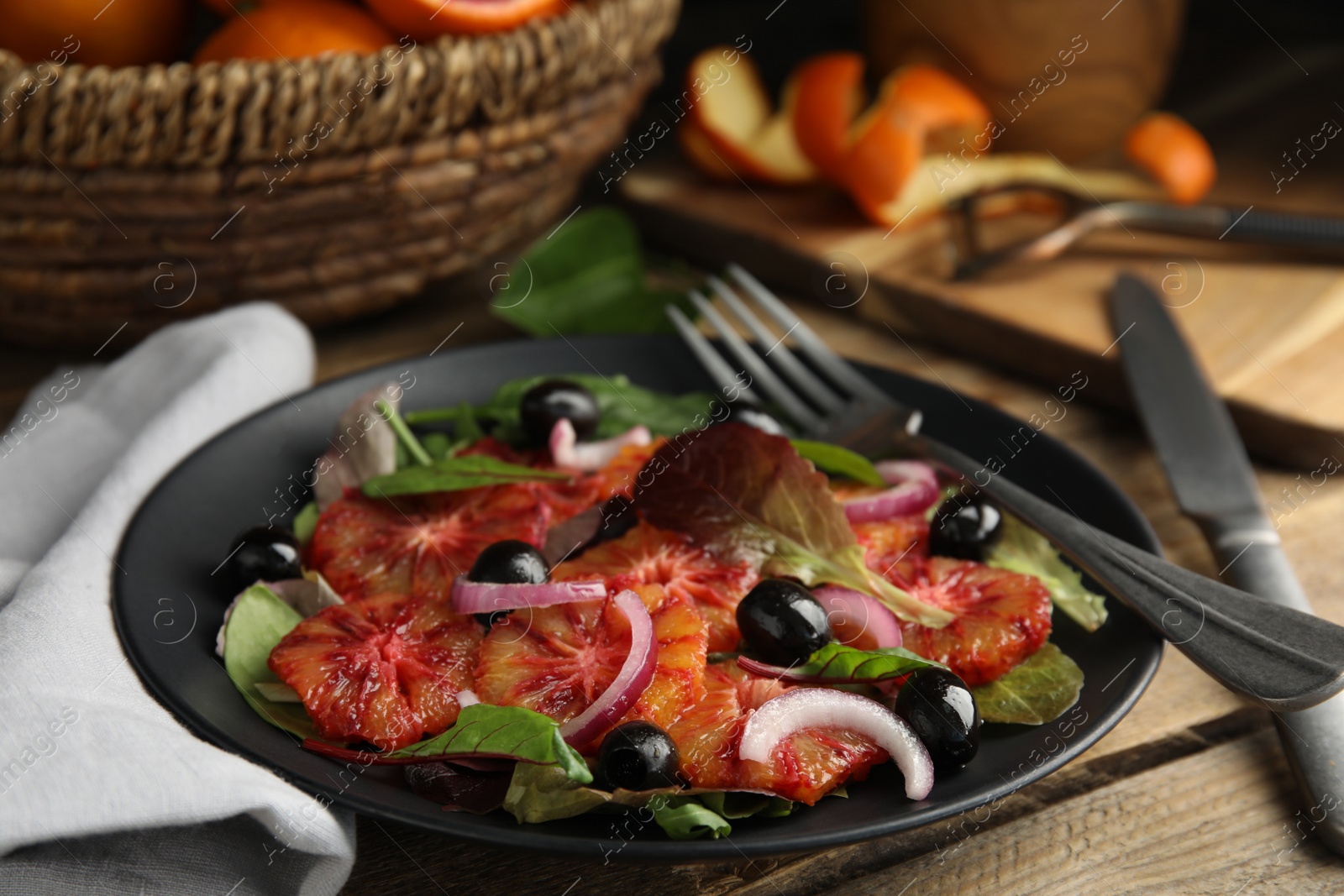 Photo of Plate of delicious sicilian orange salad on wooden table, closeup