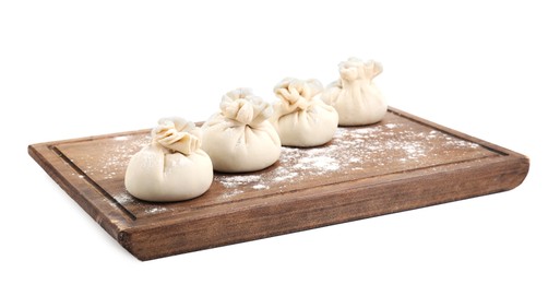 Wooden board with uncooked khinkali (dumplings) isolated on white. Georgian cuisine