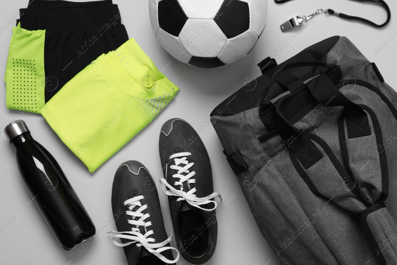 Photo of Gym bag and sports equipment on white background, flat lay