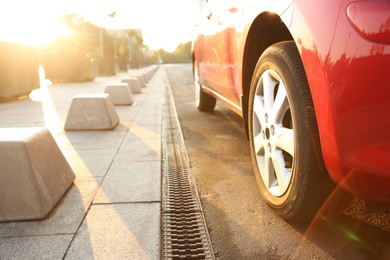 Modern red car outdoors on sunny day, closeup