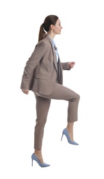Photo of Businesswoman imitating stepping up on stairs against white background. Career ladder concept