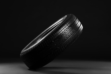 Photo of New car tire on black background