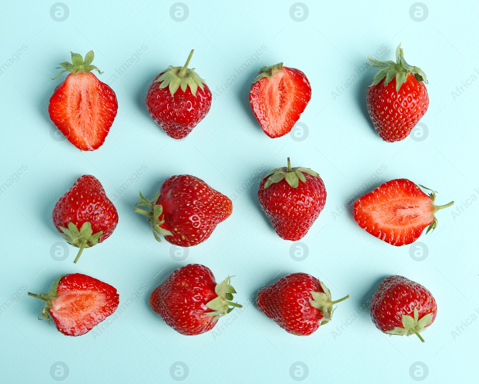 Photo of Tasty ripe strawberries on light blue background, flat lay