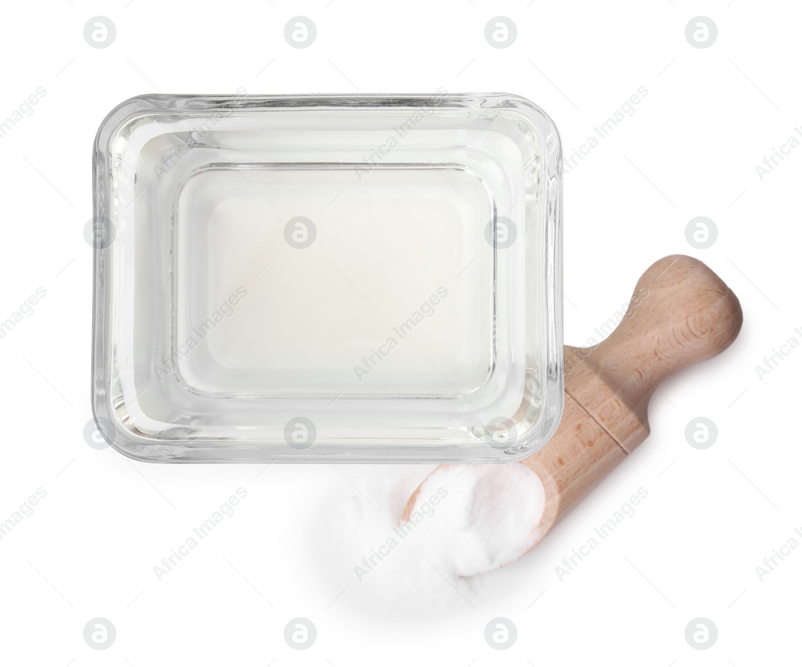 Photo of Vinegar in glass bowl, baking soda and wooden scoop isolated on white, top view