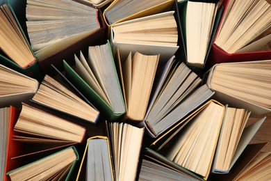 Photo of Many hardcover books as background, top view. Library material