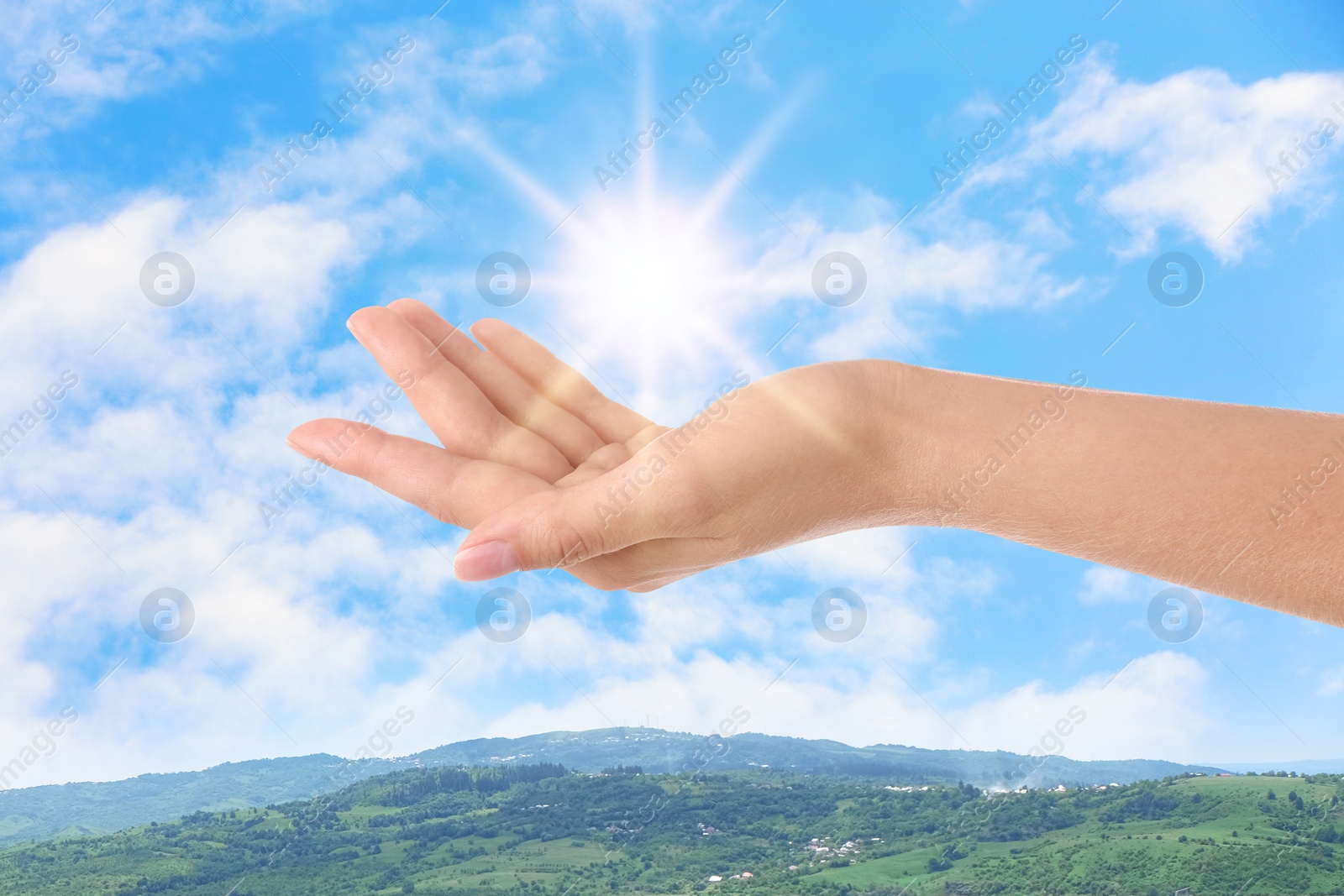 Image of Bright light in hand, closeup. Solar energy concept