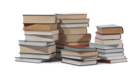 Stacks of many different books isolated on white