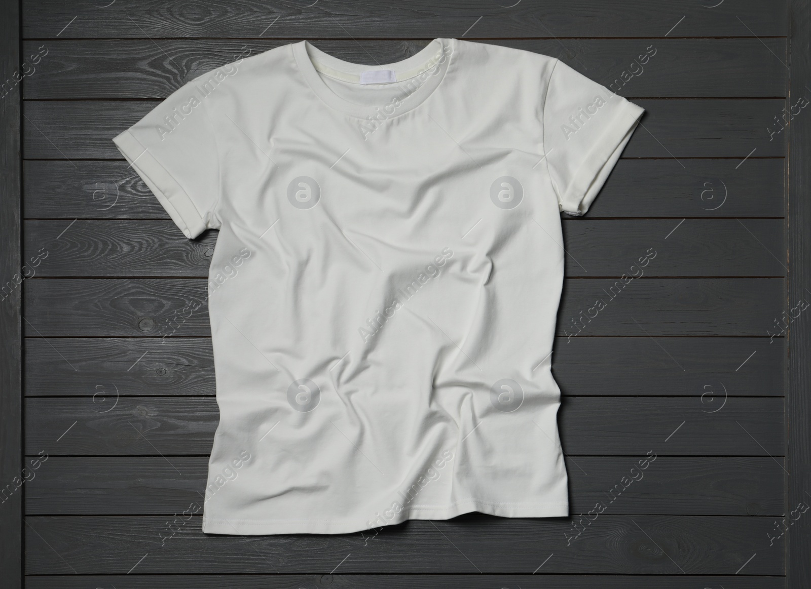 Photo of Stylish white T-shirt on gray wooden table, top view