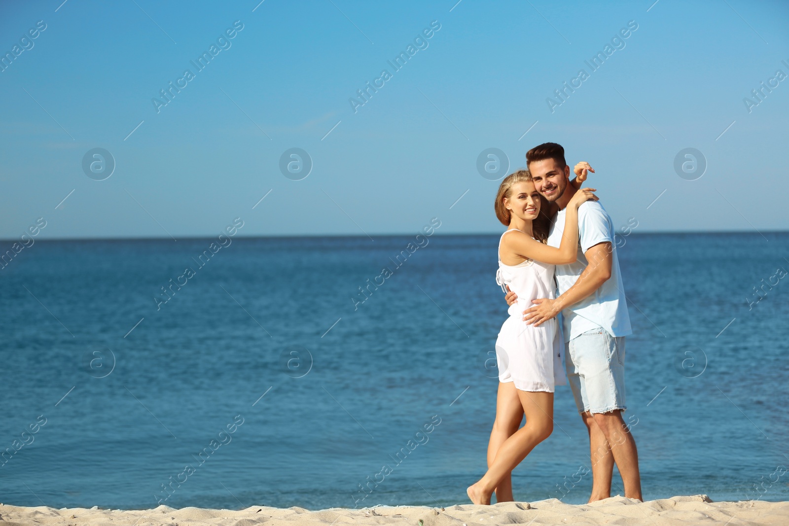 Photo of Happy young couple at beach on sunny day