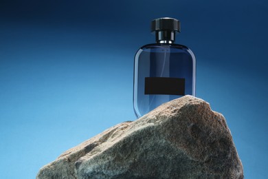 Stylish presentation of luxury men`s perfume on stone against light blue background. Space for text